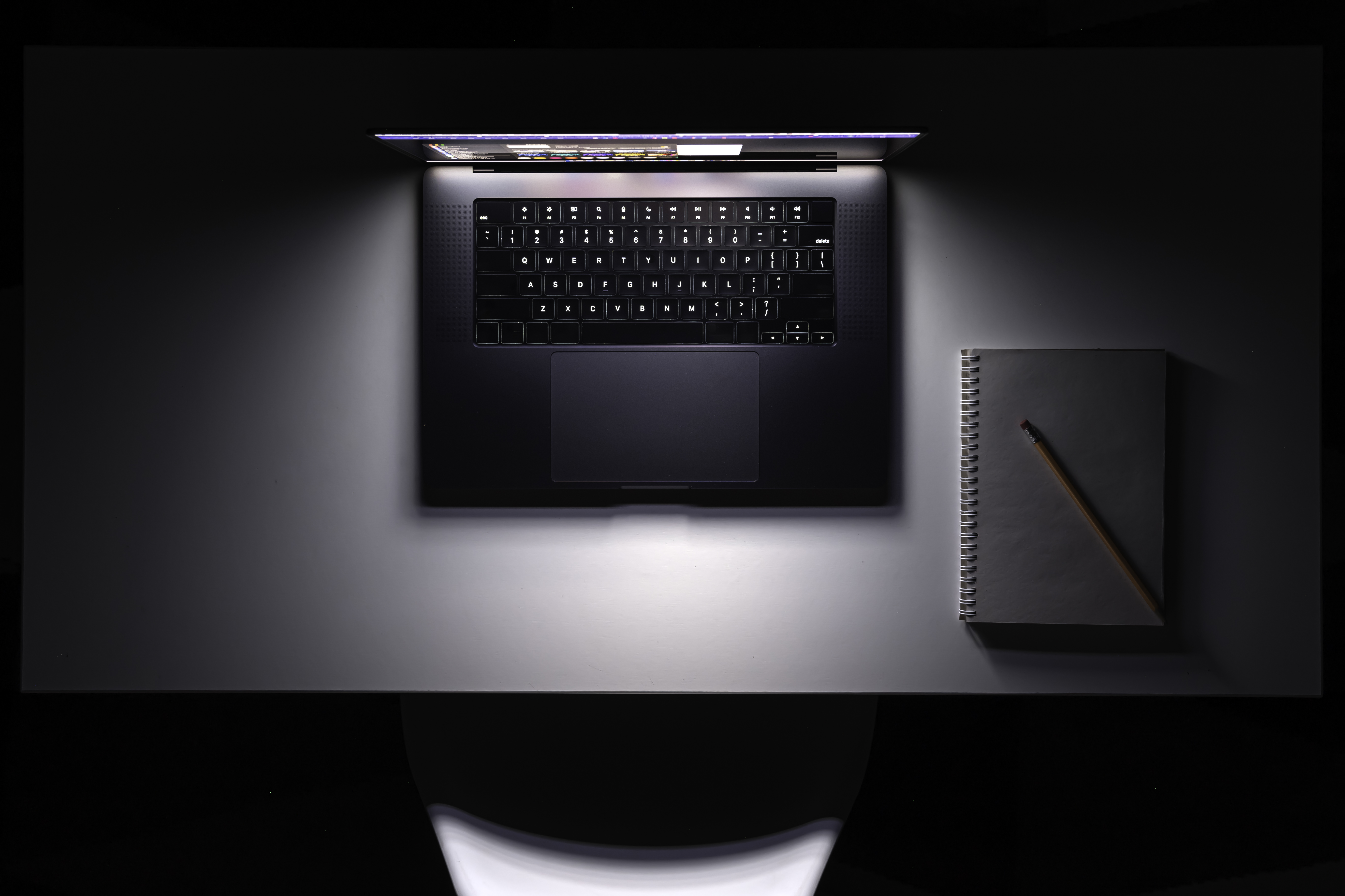 Laptop glowing at night — manage from anywhere
